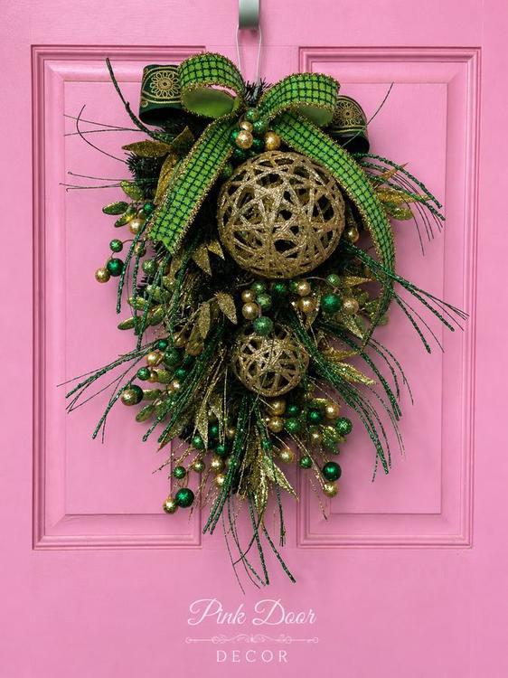 Emerald and gold glitter swag with woven gold spheres on the pink door