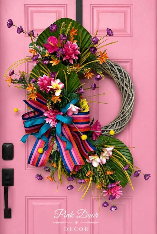 Tropical plumeria wreath on the pink door