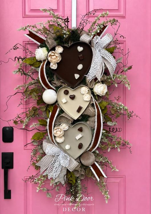 Valentine swag with three heart-shaped chocolate boxes on the pink door