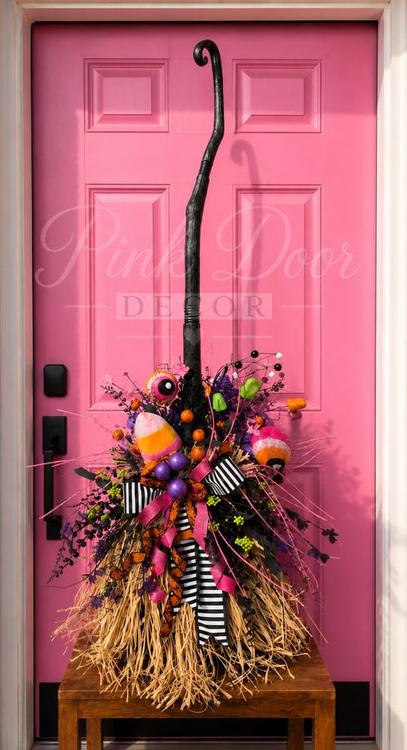 Decorated candy witch broom by the pink door